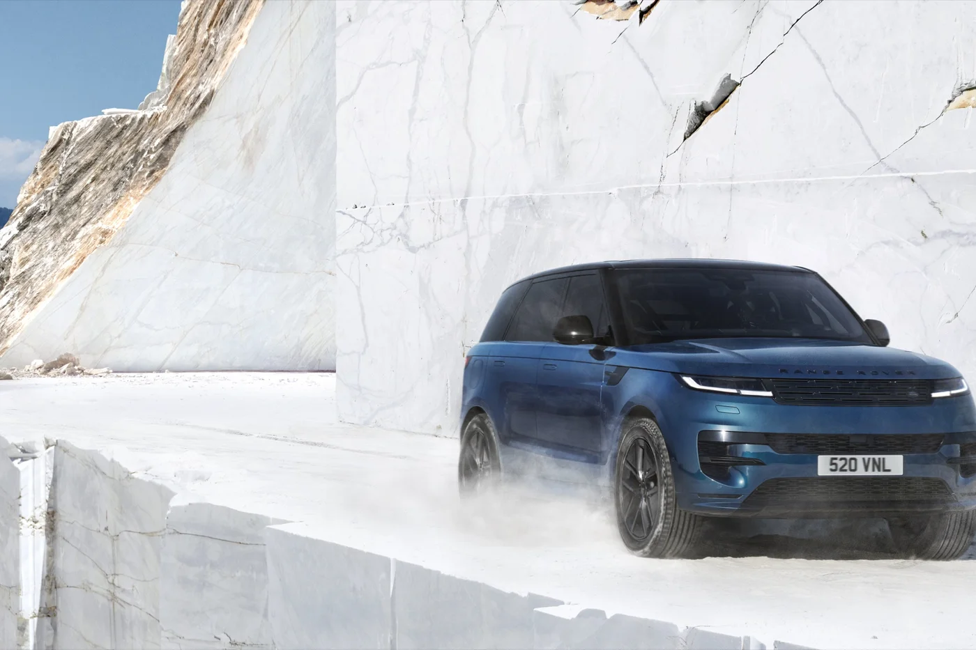 Blue Range Rover Sport Electric, front three-quarter view, on white marble