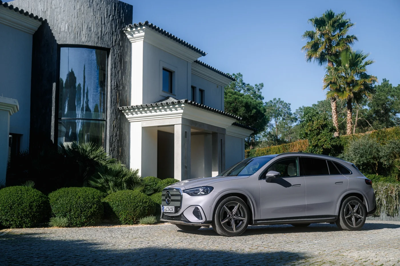 Electric Mercedes GLC parked outside a white villa