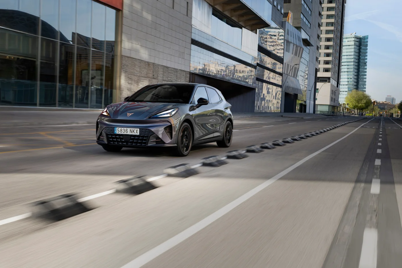 Grey Cupra Raval driving on a city road