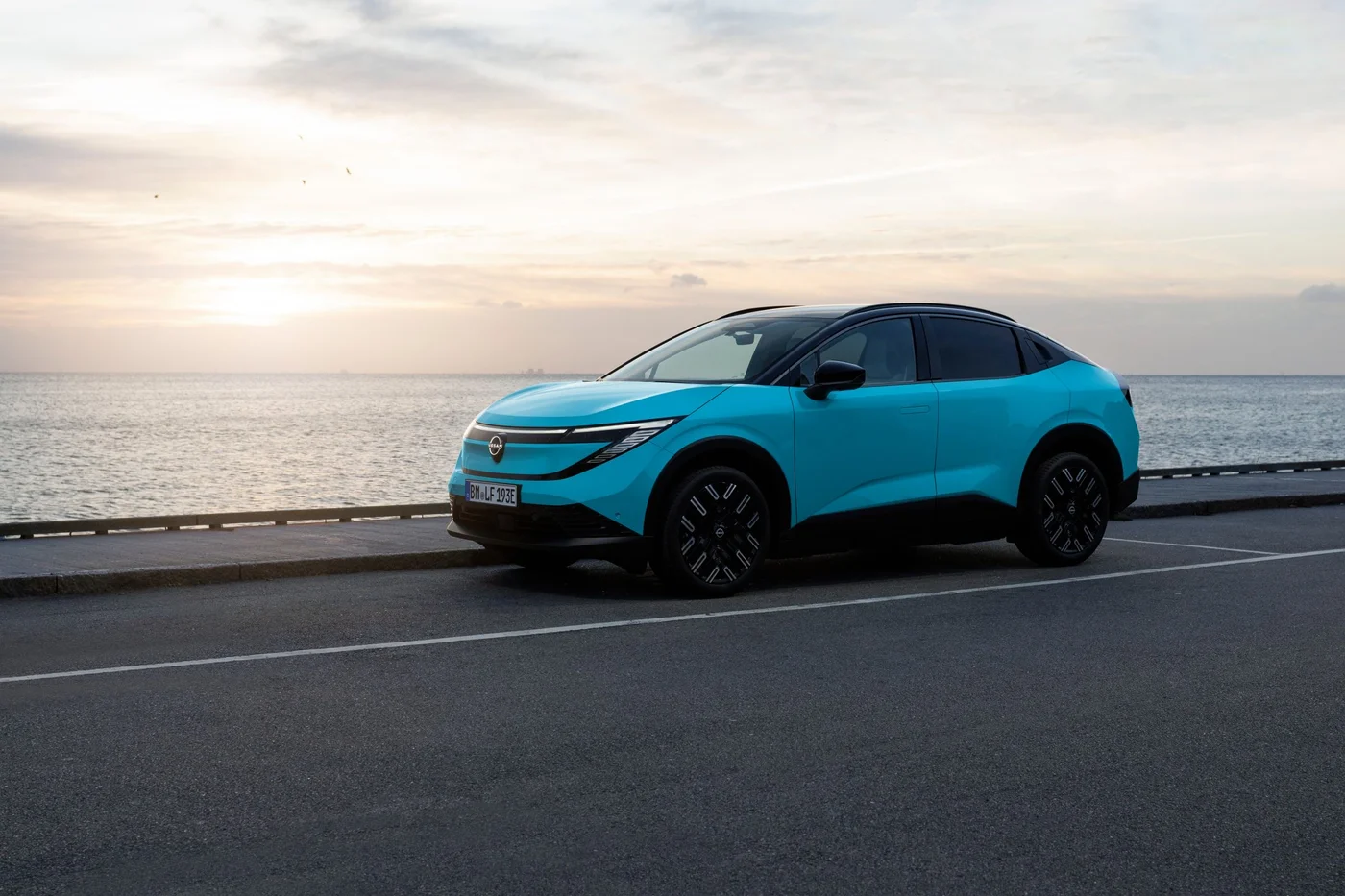 Nissan Leaf parked by the sea, side view